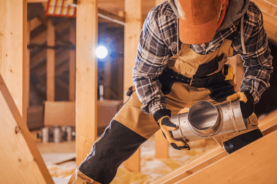 HVAC technician replacing ductwork beneath a home