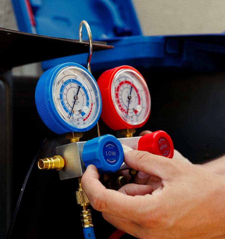 Outdoor heat pump unit receiving professional maintenance