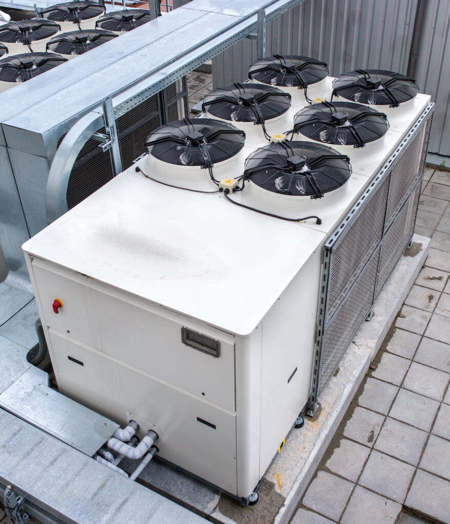 Outdoor heat pump unit receiving professional maintenance