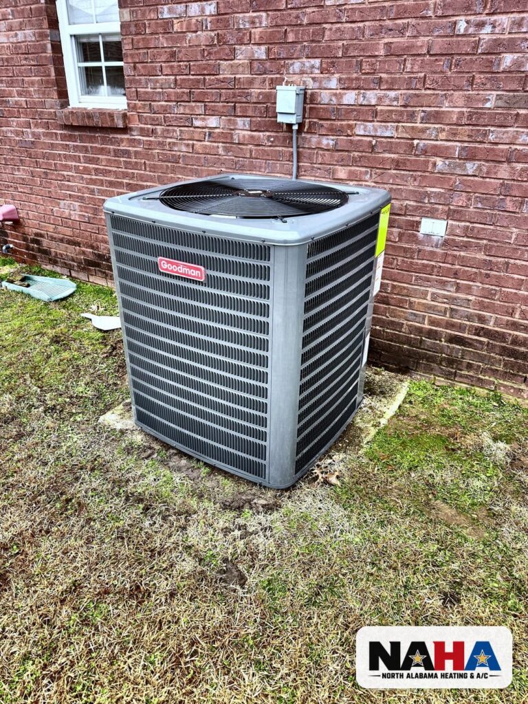 New outdoor condenser on a pad beside a brick home
