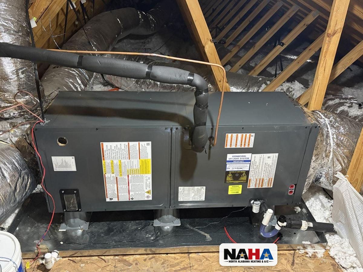 New air handler with germicidal UV light installed on a pan in a Huntsville attic
