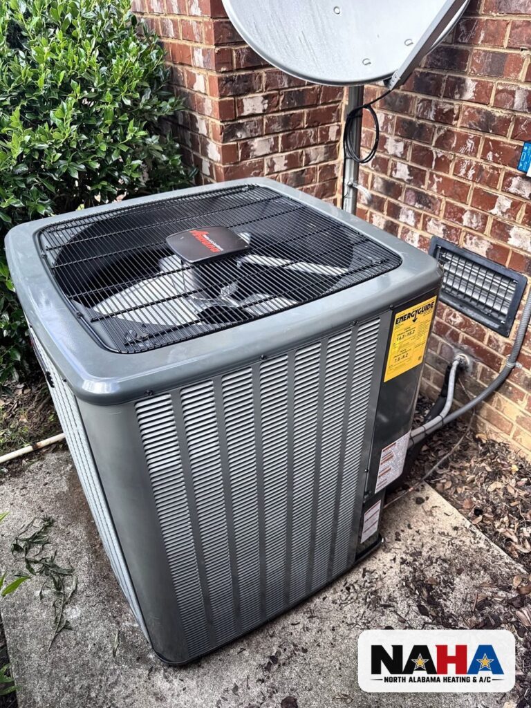 New outdoor condenser beside a brick wall