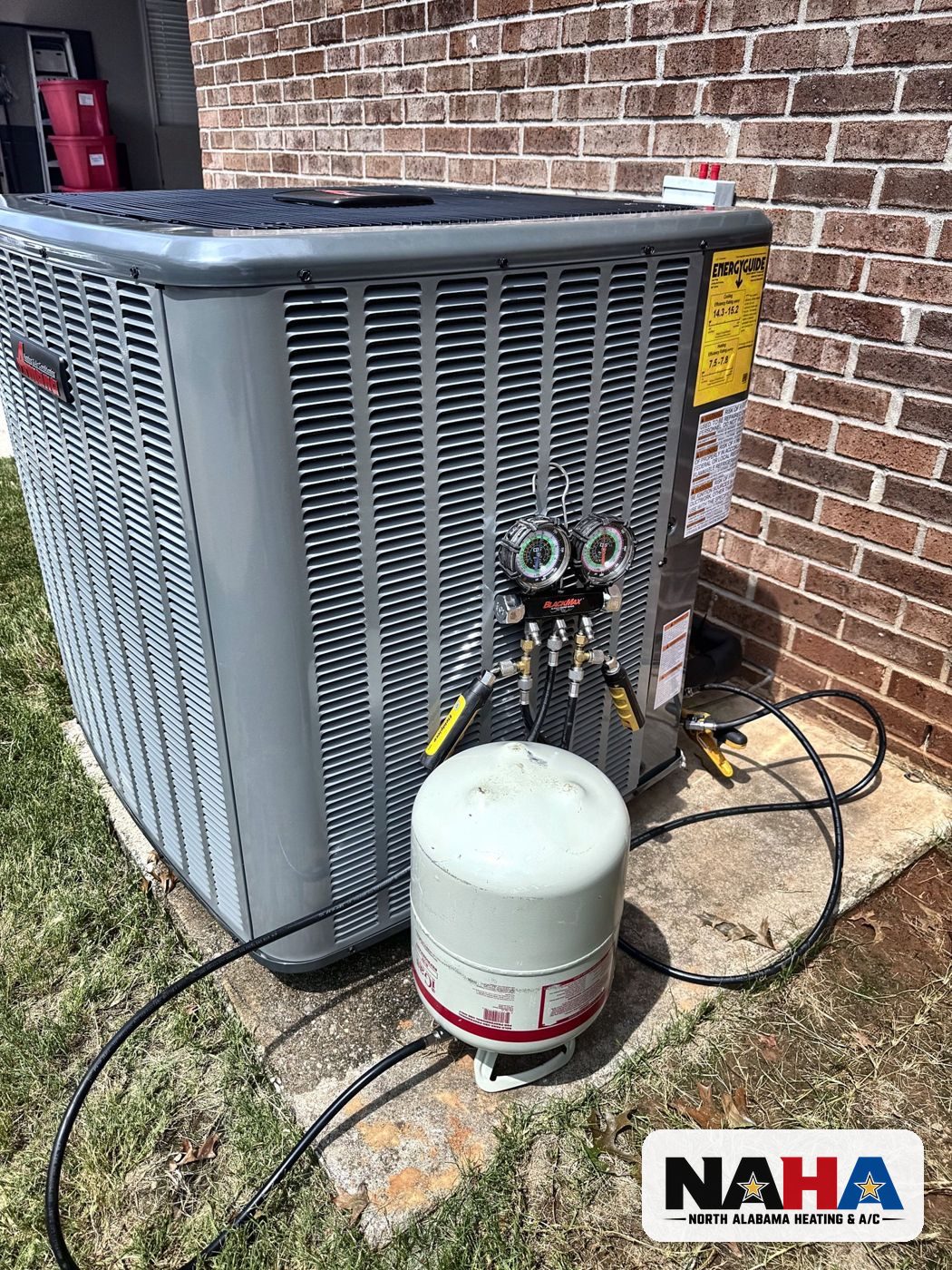 Outdoor unit with refrigerant cylinder and gauges connected