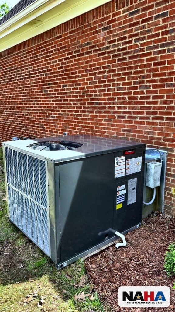 Packaged HVAC unit beside a brick house