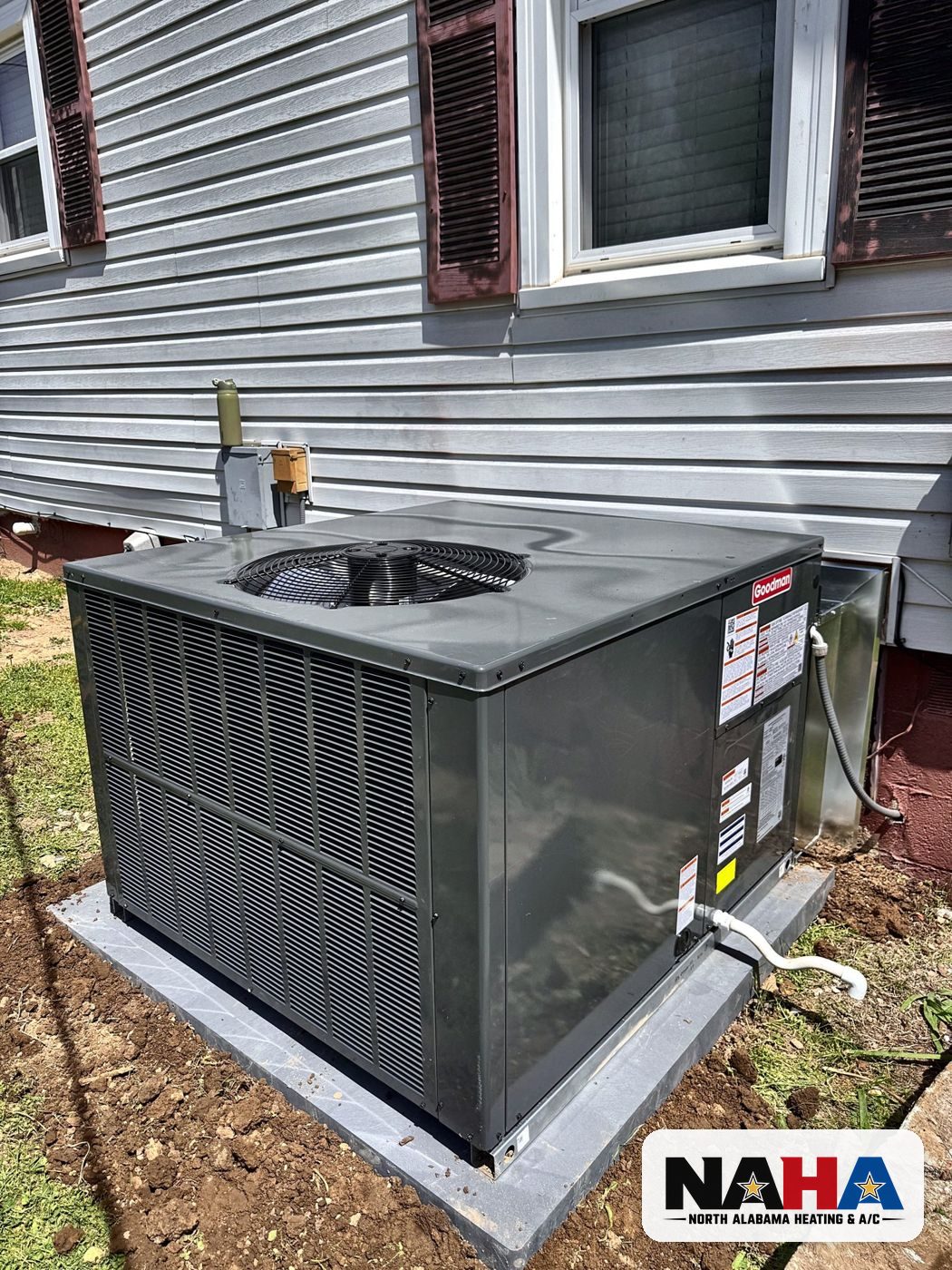 Packaged HVAC unit on a pad beside a home